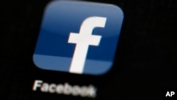 FILE - In this May 16, 2012, file photo, the Facebook logo is displayed on an iPad in Philadelphia. Facebook is under fire for failing to rein in fake and biased news stories that some believe may have swayed the presidential election. Its predicament stems from this basic conundrum: It exercises great control over the news its users see, but it declines to assume the editorial responsibility that traditional publishers do. (AP Photo/Matt Rourke, File)