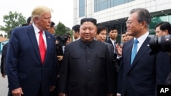 President Donald Trump meets with North Korean leader Kim Jong Un and South Korean President Moon Jae-in, right, at the border village of Panmunjom in the Demilitarized Zone, South Korea, Sunday, June 30, 2019. (AP Photo/Susan Walsh)
