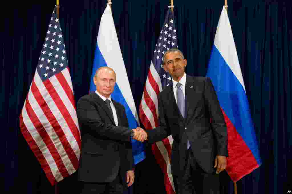 United States President Barack Obama and Russia's President President Vladimir Putin pose for members of the media before a bilateral meeting at United Nations headquarters in New York, Sept. 28, 2015.