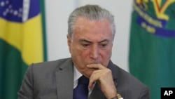 FILE - Brazil's President Michel Temer attends a ceremony at the Planalto presidential palace, in Brasilia, Brazil, April 12, 2017.
