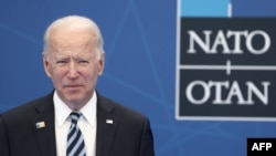 U.S. President Joe Biden arrives to be greeted and pose for a photograph with NATO Secretary General Jens Stoltenberg during the NATO summit at the North Atlantic Treaty Organization's headquarters, in Brussels, June 14, 2021.