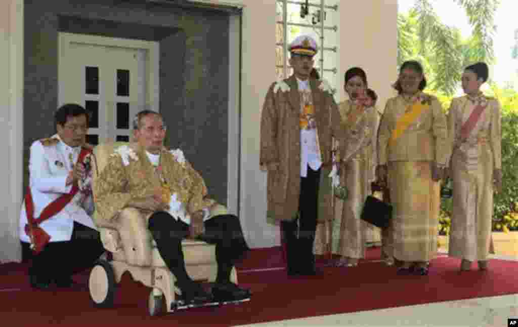In this photo released by Thailand's Royal Household Bureau, Thai King Bhumibol Adulyadej, second from left, along with Crown Prince Vajiralongkorn, third from left, Princess Chulabhorn, Princess Sirindhorn, and Consort Princess Srirasm, right, arrive at Klai Kangwon Palace before a ceremony in celebration of the king's 86th birthday in Prachuap Khiri Khan province Thailand, Dec. 5, 2013.