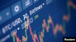 FILE - Photo illustration of Bitfinex cryptocurrency exchange website taken Sept. 27, 2017. Coinone was raided by police and tax agents in South Korea on Thursday.