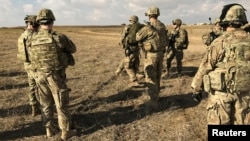 U.S. soldiers gather at a military base north of Mosul, Iraq, Jan. 4, 2017. The U.S.-led coalition has doubled the number of its military advisers in Iraq, bringing the total to 450.