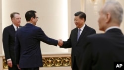លោក Steven Mnuchin (ទី២​ពីឆ្វេង) ចាប់​ដៃ​ជាមួយ​ប្រធានាធិបតី​ចិន ស៊ី ជីនពីង ខណៈ​ដែល​លោក​ Robert Lighthizer និង​ឧប​នាយក​រដ្ឋ​មន្ត្រី​ចិន Liu He កំពុង​ឈរ​មើល​នៅ​សាល​ប្រជាជនចិន ក្នុង​ទីក្រុង​ប៉េកាំង កាល​ពី​ថ្ងៃ​ទី​១៥ កុម្ភៈ ២០១៩។