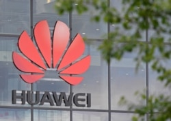 FILE - Signage is seen at the Huawei offices in Reading, Britain, May 2, 2019.