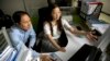 FILE - He Jiankui, left, and Zhou Xiaoqin work a computer at a laboratory in Shenzhen in southern China's Guangdong province, Oct. 10, 2018. 