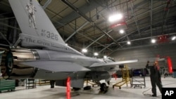 FILE - A U.S. F-16 fighter jet is seen in a hangar in South Burlington, Vermont.
