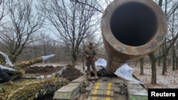 Seorang prajurit Ukraina berdiri di atas tank dekat kota garis depan Bakhmut, di tengah serangan Rusia terhadap Ukraina, di wilayah Donetsk, Ukraina 13 Januari 2023. (REUTERS/Vladyslav Smilianets)