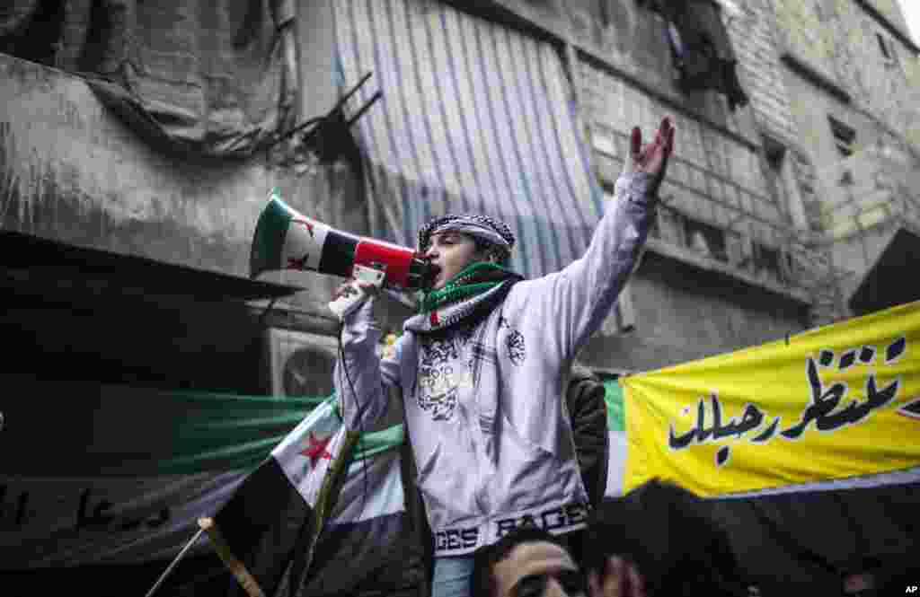 A child uses a megaphone to lead others in chanting Free Syrian Army slogans during a demonstration in Bustan Al-Qasr, Aleppo, Syria, January 4, 2013.