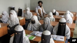 FILE - Afghan girls attend a religious school, which remained open since the last year's Taliban takeover, in Kabul, Afghanistan, on Aug. 11, 2022. (AP Photo/Ebrahim Noroozi, File)