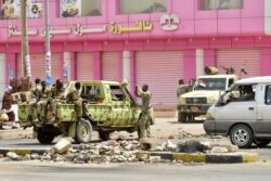 FILE - Sudanese soldiers stand guard in Khartoum, June 9, 2019. Sudanese police had fired tear gas at protesters taking part in a civil disobedience campaign.