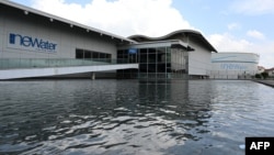 This picture taken on July 27, 2021 shows a tank (R) for processed used water storage outside the Bedok NEWater plant in Singapore. 