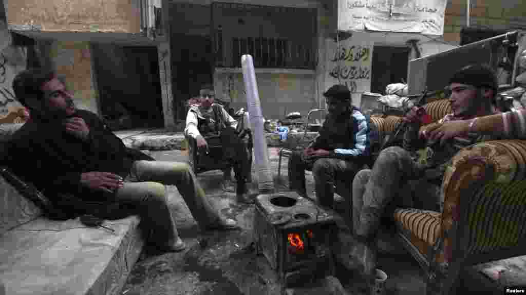 Free Syrian Army fighters sit together as they rest in Deir al-Zor, Nov. 25, 2013.