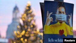 A poster reads "I protect you" during the local coronavirus disease (COVID-19) lockdown in Dresden, Germany, December 14, 2020