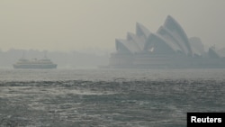 The Sydney Opera House can be seen as smoke haze from bushfires in New South Wales blankets the CBD in Sydney, Australia, Dec. 10, 2019. 