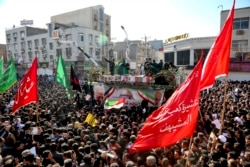 In this photo provided by The Iranian Students News Agency, flag draped coffins of Gen. Qassem Soleimani and his comrades who were killed in Iraq in a U.S. drone strike, carried on a truck during their funeral in Ahvaz, Iran, Jan
