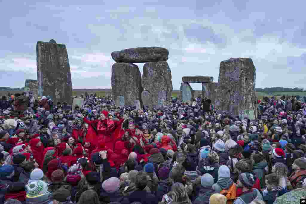 People celebrate the Winter Solstice sunrise celebrations at Stonehenge, England, Dec. 21, 2024.