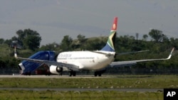 A South African Airways plane is parked at the end of the runway after returning to the airport in Cape Town, South Africa, Saturday June 17, 2006. A 21-year-old man was arrested after trying to force his way into the cockpit shortly after takeoff on flig