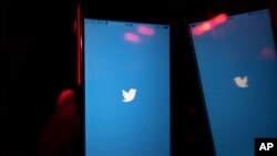 A mobile phone user turns on Twitter application on his smartphone in Moscow, Russia, March 10, 2021.