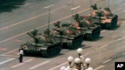 FILE - In this June 5, 1989, file photo, a Chinese man stands alone to block a line of tanks heading east on Beijing's Changan Boulevard in Tiananmen Square.