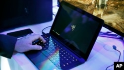 FILE - A laptop is seen in this Jan. 7, 2016. Royal Jordanian Airlines advised passengers that laptops, iPads, cameras and other electronics won’t be allowed in carry-on luggage for U.S.-bound flights starting March 21, 2017.