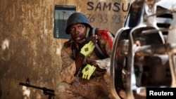 A Malian soldier looks on during fighting with Islamists in Gao, Feb. 21, 2013.