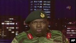 FILE: In this image made from video, Major Gen. S.B. Moyo, Spokesperson for the Zimbabwe Defense Forces addresses to the nation in Harare, Zimbabwe, Nov. 15, 2017. 