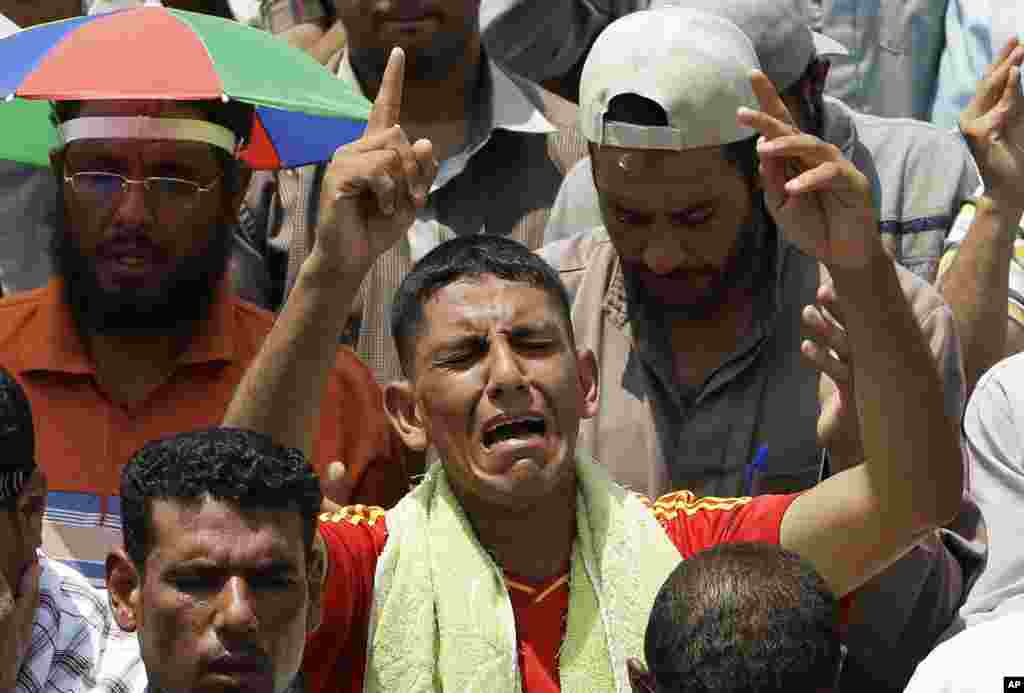 A supporter of Egypt's ousted President Mohammed Morsi offers his Friday prayer where protesters have installed their camp and held their daily rally, at Nasr city, Cairo, Egypt, July 19, 2013. 