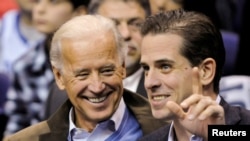 FILE - Then-U.S. Vice President Joe Biden and his son Hunter Biden attend a basketball game between Georgetown University and Duke University in Washington, U.S., January 30, 2010. (REUTERS/Jonathan Ernst/File Photo)