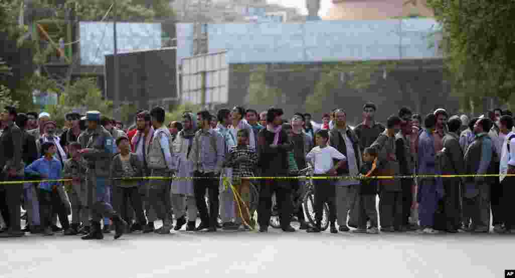 Afghans gather after a suicide car bombing attack in Kabul, May 19, 2015. 