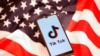 Tik Tok logo is displayed on a smartphone on the U.S. flag in this illustration 