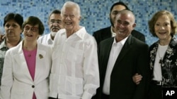 Authorities, front row, from left, Adela Dworin, President of the Cuban Jewish Community, former President Jimmy Carter, David Prinstein, Vice-President of the Cuban Jewish Community and Carter's wife Rosalynn Carter, pose for pictures during a visit to 