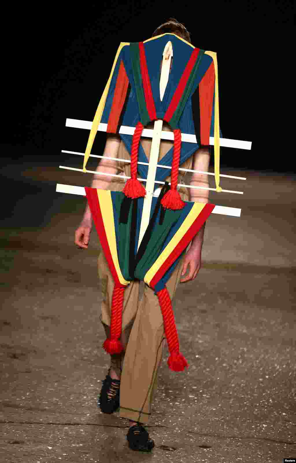 A model presents a creation at the Craig Green catwalk show at London Fashion Week Men's.