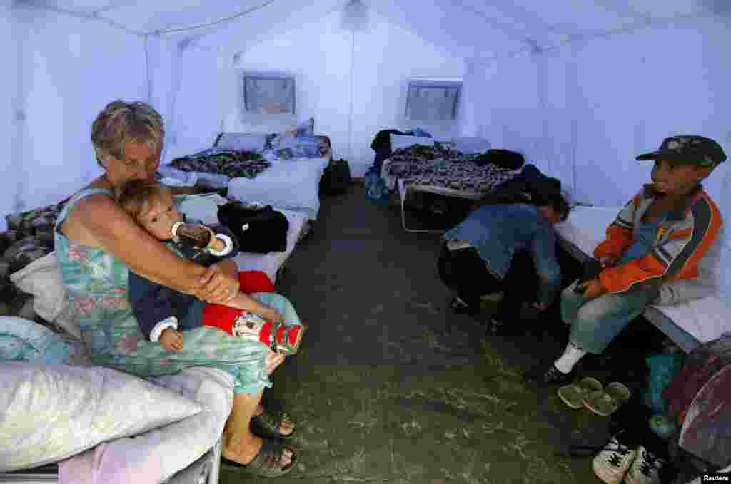 Families pour into Ukrainian refugee encampments, outside Donetsk, Aug. 18, 2014. 