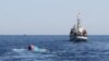 FILE - A Vietnamese sinking boat (L) which was rammed and then sunk by Chinese vessels near disputed Paracels Islands, is seen near a Marine Guard ship (R) at Ly Son island of Vietnam's central Quang Ngai province.