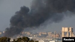 Smoke rises inside central Gaza strip following an airstrike, as seen from southern Israel