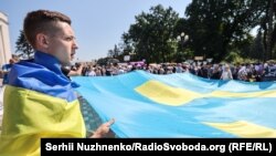 Акция под Верховной Радой Украины. Люди написали пожелания на большом крымскотатарском флаге, который запустят в Крым ко Дню крымскотатарского флага. Киев, 15 июня, 2021