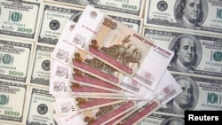A picture illustration shows U.S. dollar and Russian ruble banknotes in Sarajevo, March 9, 2015. 