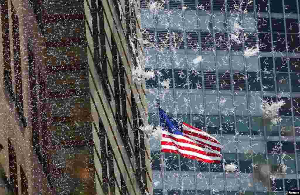 Paper falls from buildings during the ticker-tape parade for the U.S. women's soccer team up Broadway in lower Manhattan to celebrate their World Cup final win over Japan in New York, July 10, 2015.