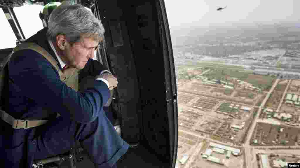 U.S. Secretary of State John Kerry, who arrived in Baghdad on Wednesday as he began a tour of the Middle East to build a coalition against the Islamic State militants, looks out over Baghdad from a helicopter, Sept. 10, 2014.