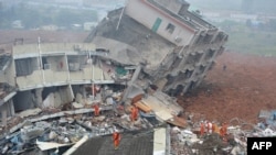 Rescuers look for survivors after a landslide hit an industrial park in Shenzhen, south China's Guangdong province on Dec. 20, 2015.