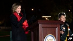 Speaker of the House Nancy Pelosi of Calif., and Coche Tiger, 9, a member of the Eastern Band of Cherokee Indians, at the U.S. Capitol Christmas Tree Lighting Ceremony, Tuesday, Nov. 29, 2022. (AP Photo/Jacquelyn Martin)