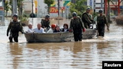 Japan Self-Defense Force soldiers rescue people from a flooded area in Mabi town in Kurashiki, Okayama Prefecture, Japan, July 8, 2018.