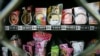 FILE - Condoms are seen above chewing gum and food snacks in a vending machine in China, Sept. 23, 2007. State law limits what Yale University in Connecticut can dispense in its campus vending machines.