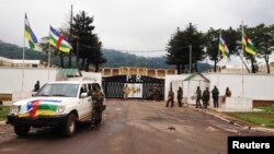 FILE - Fighters of the Seleka rebel coalition stand in front of the presidential palace in Bangui, Central African Republic, March 25, 2013.