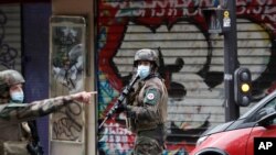 French soldiers patrol after a knife attack near the former offices of satirical newspaper Charlie Hebdo, in Paris, France, Sept. 25, 2020.