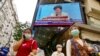 FILE - A TV screen broadcasts Hong Kong Chief Executive Carrie Lam during a news conference in Hong Kong, March 30, 2021. 