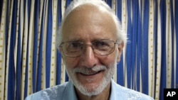 FILE - In this Nov. 27, 2012 file photo provided by James L. Berenthal, shows jailed American Alan Gross poses for a photo during a visit by Rabbi Elie Abadie and U.S. lawyer James L. Berenthal at Finlay military hospital in Cuba.