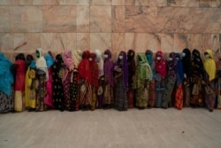 Wearing protective masks, women stand in line to enter the Grand Mosque of Touba as they take part in the celebrations of the Grand Magal of Touba, Senegal, Oct. 5, 2020.